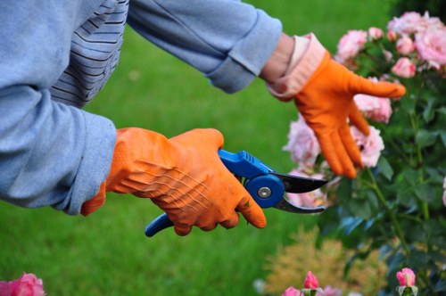 Volunteers loading reusable tools into a charity van at a garden site